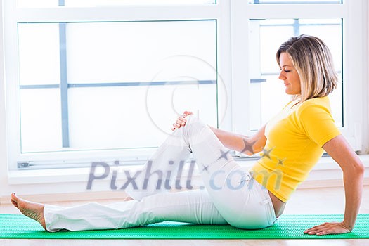 Pretty young woman doing YOGA exercise at home Pretty young woman doing YOGA exercise at home