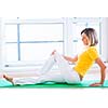 Pretty young woman doing YOGA exercise at home