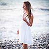 Young woman on the beach enjoying a warm summer evening