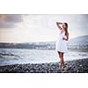 Young woman on the beach enjoying a warm summer evening