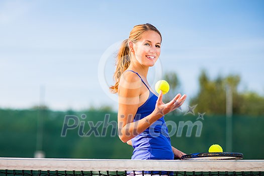 Portrait of a pretty young tennis player with copyspace