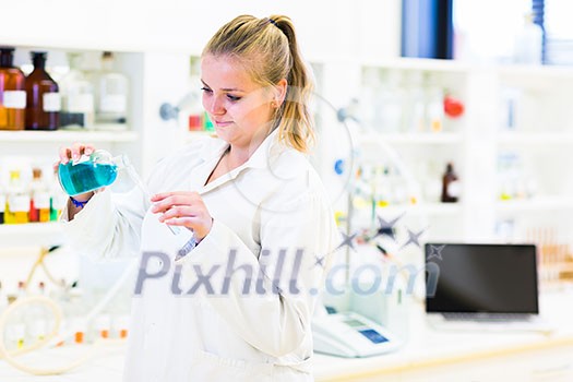 Portrait of a female researcher carrying out research in a chemistry lab (color toned image; shallow DOF) Portrait of a female researcher carrying out research in a chemistry lab (color toned image; shallow DOF)