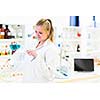 Portrait of a female researcher carrying out research in a chemistry lab (color toned image; shallow DOF)