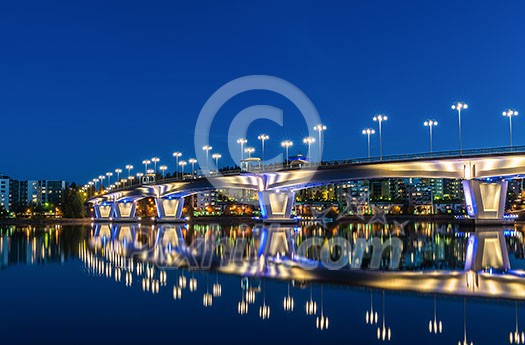 Brightly lit bridge over river