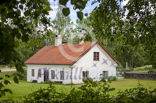 White stone house on green countryside