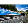 Fast train passing through a tunnel on a lovely summer day (motion blurred image)