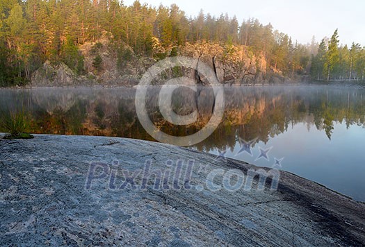 Rock surface by early morning lake view