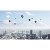 Conceptual image with colorful balloons flying high in sky