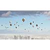 Conceptual image with colorful balloons flying high in sky