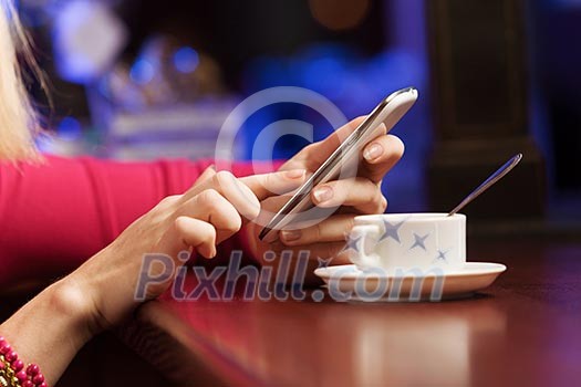 Young attractive lady at bar talking on phone