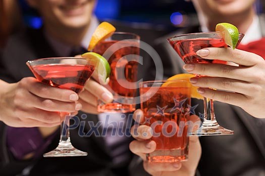 Young attractive people of four having cocktail party