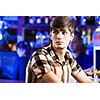 Young man in shirt sitting at bar