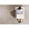 Top view of businesswoman sitting in chair and reading book