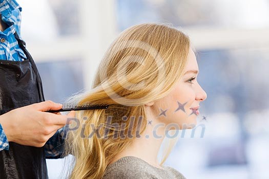 Young woman in chair at barbers and hairdresser Young woman in chair at barbers and hairdresser