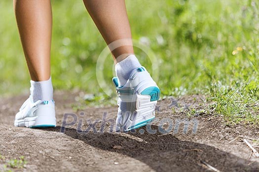 Close up of female feet running on road Close up of female feet running on road