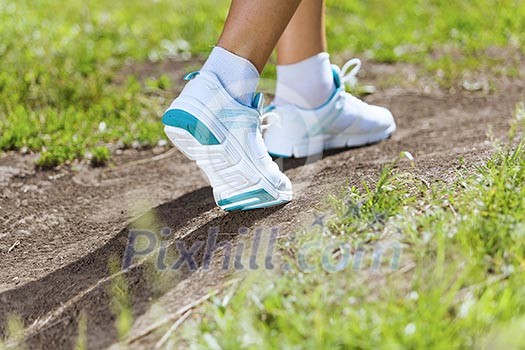 Close up of female feet running on road Close up of female feet running on road