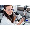 Portrait of a female chemistry student carrying out research in a chemistry lab (color toned image; shallow DOF)