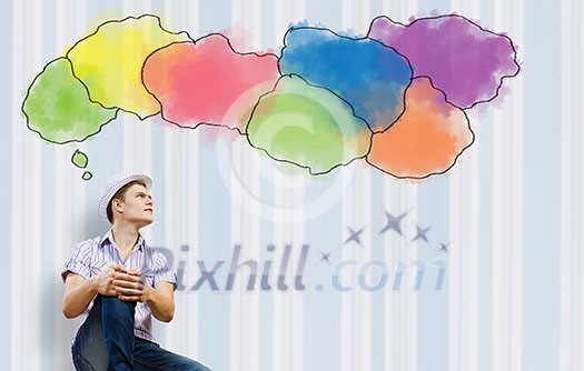 Young man in casual sitting and thinking. Creativity concept Young man in casual sitting and thinking. Creativity concept