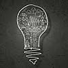 Conceptual image of light bulb on black wall
