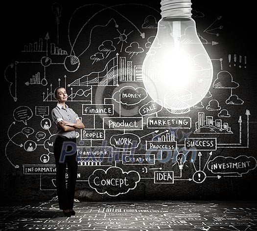 Young businesswoman with bulb and business sketches at background Young businesswoman with bulb and business sketches at background