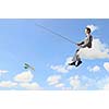 Businessman sitting on cloud and fishing with rod