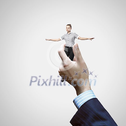 Young businesswoman in miniature in hand of businessman Young businesswoman in miniature in hand of businessman