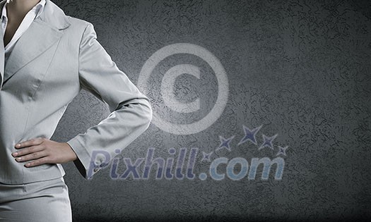 Chest view of businesswoman in suit against cement wall Chest view of businesswoman in suit against cement wall