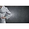Chest view of businesswoman in suit against cement wall