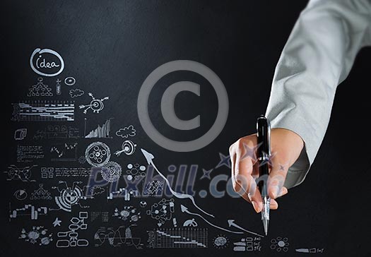 Close up of businesswoman hand drawing business sketches Close up of businesswoman hand drawing business sketches