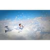 Young businessman flying in sky and playing fife