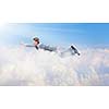Young super businessman flying high in sky