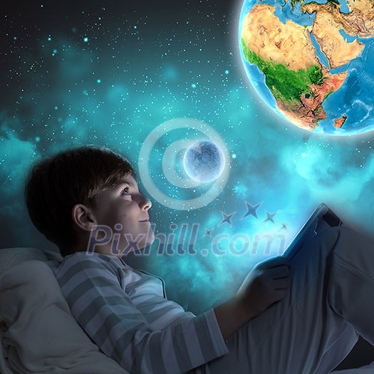 Boy sitting in bed and dreaming. Elements of this image are furnished by NASA