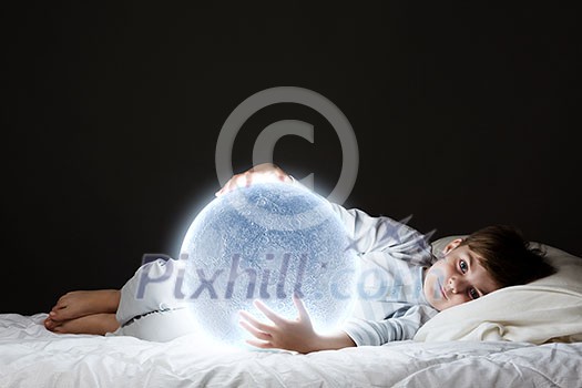 Cute boy sleeping in bed with moon