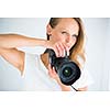 Pretty, female photographer with digital camera - DSLR  (color toned image; shallow DOF)