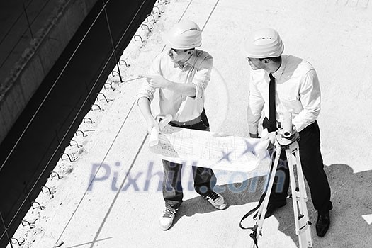 Team of architects people in group on construciton site check documents and business workflow Team of architects people in group on construciton site check documents and business workflow