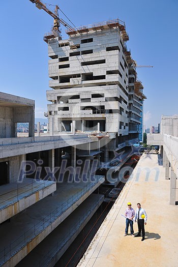 Team of architects people in group on construciton site check documents and business workflow Team of architects people in group on construciton site check documents and business workflow