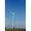 wind turbine  generating eco friendly renewable  electricity energy on blue sky