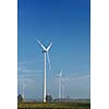 wind turbine  generating eco friendly renewable  electricity energy on blue sky