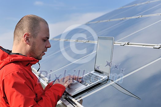 business man engineer using laptop at solar panels plant eco energy field in background business man engineer using laptop at solar panels plant eco energy field in background