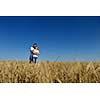 happy young couple in love have romance and fun at wheat field in summer