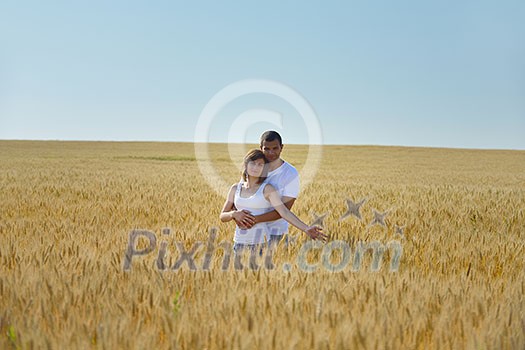 happy young couple in love have romance and fun at wheat field in summer