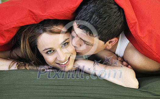 happy young couple in bed at morning