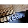 wooden luxury sauna indoor with hot stones and falling splashing water