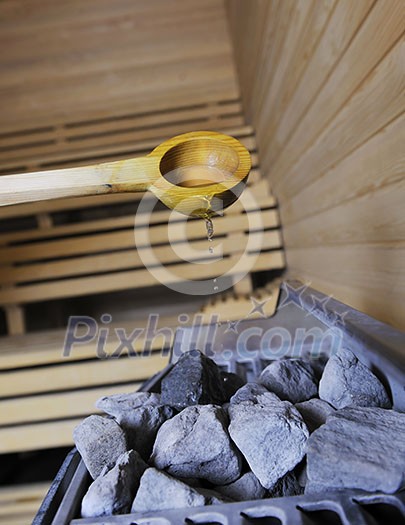 wooden luxury sauna indoor with hot stones and falling splashing water wooden luxury sauna indoor with hot stones and falling splashing water