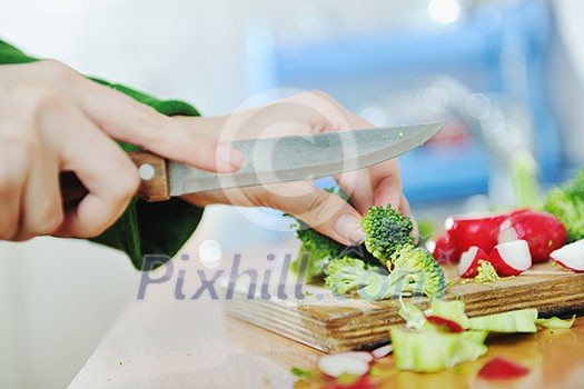 woman preparing healthy food salad with green and red vegetable and knife woman preparing healthy food salad with green and red vegetable and knife