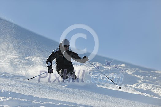 man ski free ride downhill at winter season on beautiful sunny day