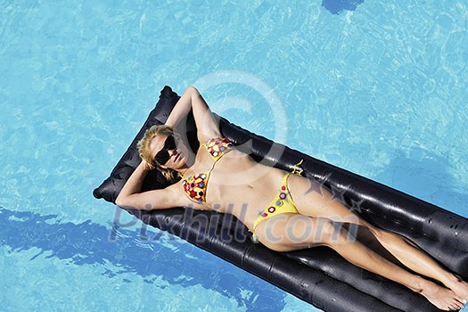 beautiful young woman relax and have fun at swimming pool