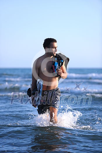 Portrait of a strong young surf man at beach on sunset in a contemplative mood with a surfboard Portrait of a strong young surf man at beach on sunset in a contemplative mood with a surfboard