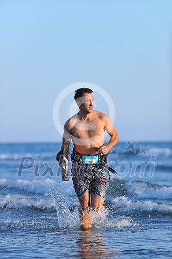 Portrait of a strong young surf man at beach on sunset in a contemplative mood with a surfboard Portrait of a strong young surf man at beach on sunset in a contemplative mood with a surfboard