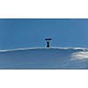 snowboarder relaxing and posing at sunny day on winter season with blue sky in background